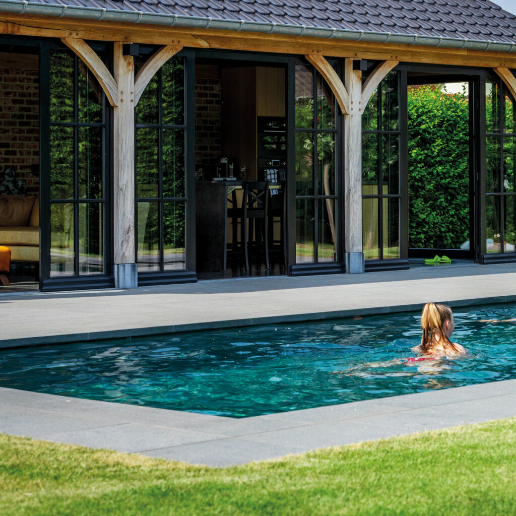 Rechthoekig vinylester monoblok zwembad strak geïntegreerd in een moderne tuin